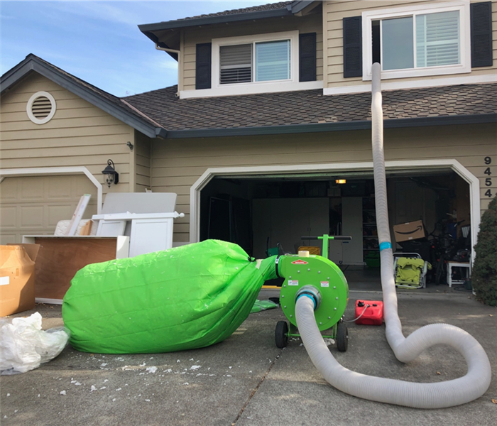 Insulation being bagged via vacuum removal by SERVPRO 
