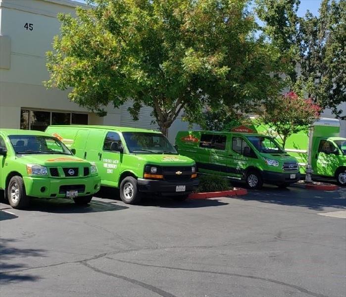 SERVPRO vans. trucks, and cars in parking lot
