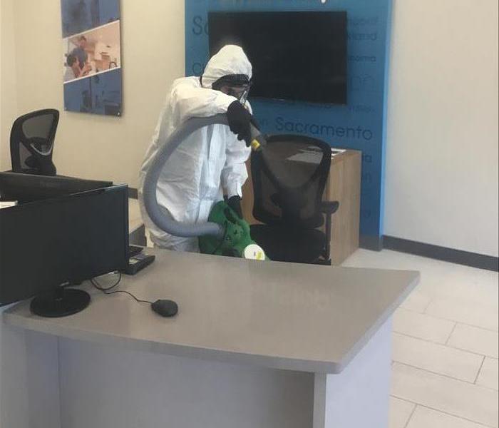 SERVPRO technician disinfecting an office
